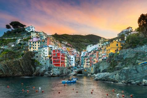 A stunning panoramic view of the colorful houses of Cinque Terre clinging to the cliffs with the Ligurian Sea below