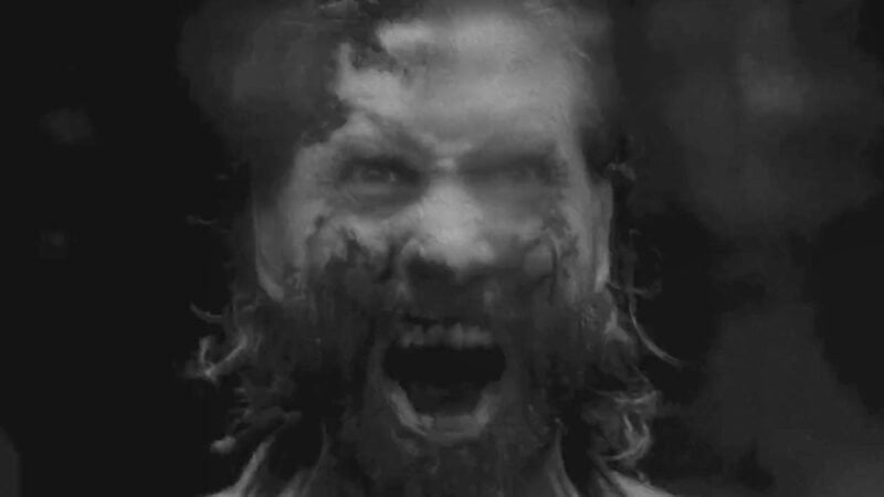 Alan Wake exploring the Dark Place, showcasing the game's impressive lighting and textures