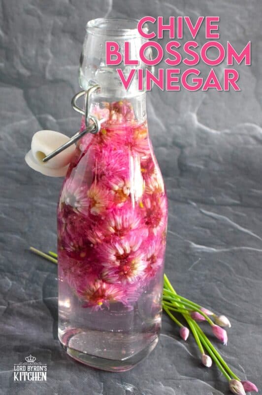 Fresh herbs are packed loosely into sterilized glass jars in preparation for being infused with vinegar.