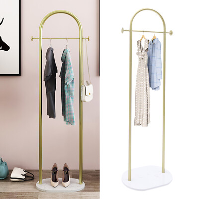 A wall-mounted coat rack with simple, clean lines holding a few essential winter coats, reflecting the minimalist aesthetic of Scandinavian design.