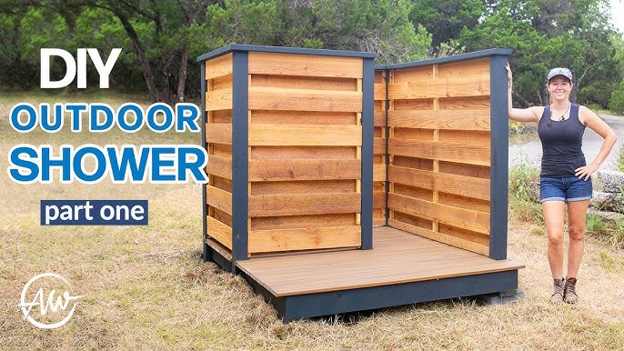 View of the completed shower from the outside, showing the pallet walls and wattle fence blending into the natural surroundings.
