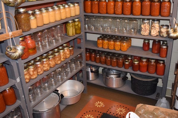 Rows of neatly organized canned goods stored on shelves