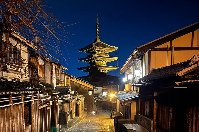 A street scene in Gion at night, with lanterns illuminating the traditional wooden buildings