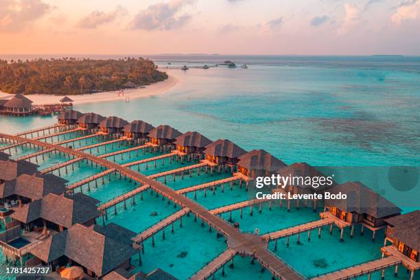 Couple enjoying a sunset dinner at the overwater bungalow