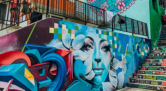 David participating in a graffiti workshop in Comuna 13, looking focused and slightly unsure of himself.