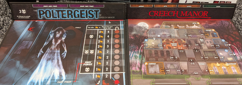 A cluttered desk with energy drink cans, snack wrappers, and a gaming keyboard, illuminated by a harsh fluorescent desk lamp.