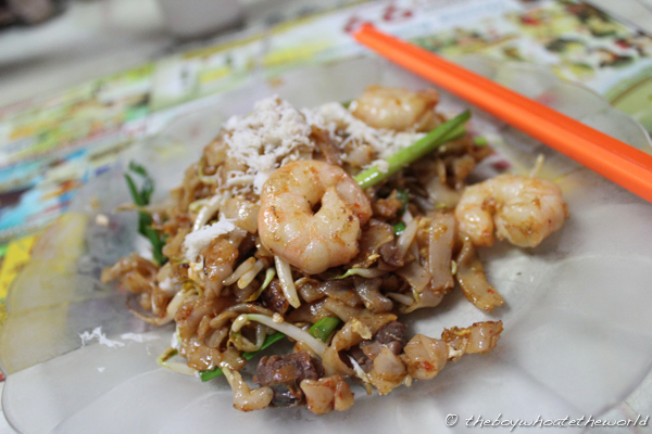 A plate of Char Kway Teow with a fried egg.