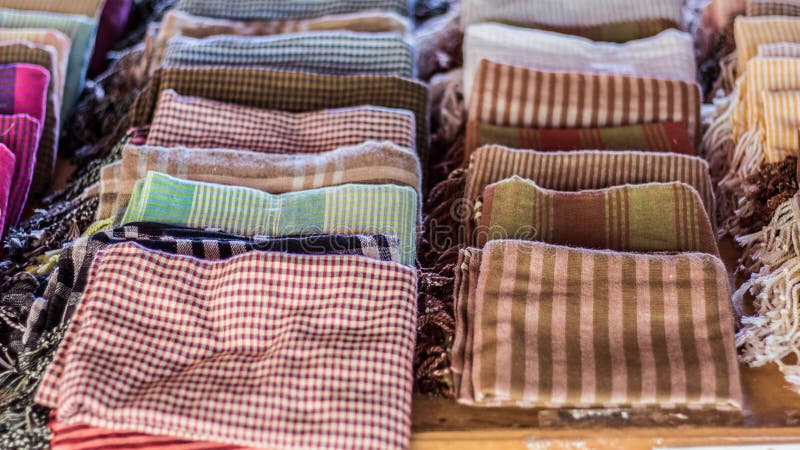 Close-up, top-down photo of finished Amok, garnished with fresh basil, sliced red chilies, and a swirl of coconut cream. The photo should be brightly lit, and shot at f/2.8 to blur the background