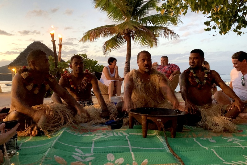 The family snorkeling in crystal clear turquoise water with vibrant coral reefs visible below.