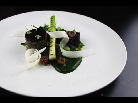 Interior view of The Dylan Amsterdam's wine cellar, showing the low vaulted ceiling, exposed brick walls, and soft lighting, creating an intimate atmosphere.