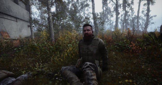 A developer with two monitors coding C# script in Visual Studio. The person is focused and the room lighting is dim.