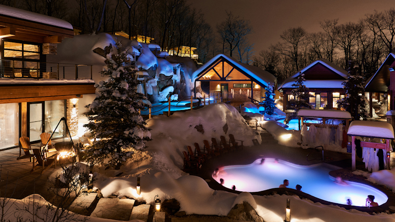 Outdoor hot pools at Strøm Nordic Spa with snow-covered trees in the background