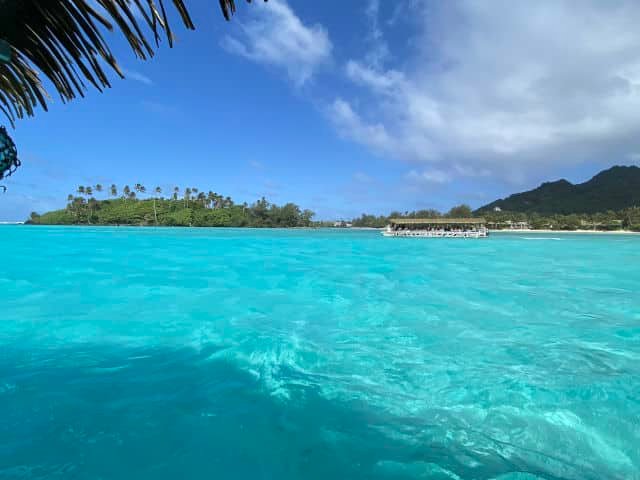Aerial view of Aitutaki Lagoon showcasing its turquoise waters and the surrounding motus