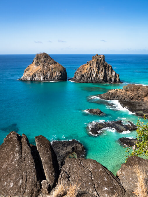 Kitesurfer riding a wave in Fernando de Noronha, Brazil