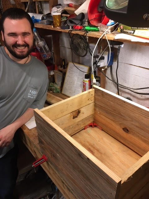 Close-up of a hand applying food-safe sealant to the interior of the beehive, showcasing the smooth application and protective properties of the sealant. Soft, diffused light.