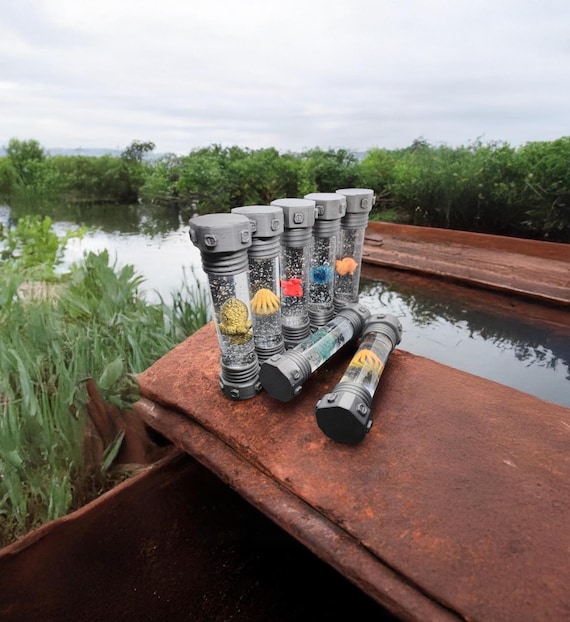 A close-up screenshot reveals the intricate details of a rusting pipe and moss-covered concrete in Stalker 2. The lighting and texture work showcase the game's high graphical fidelity.