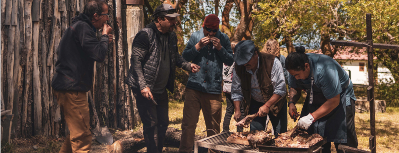 Mount Fitz Roy reflected in a pristine alpine lake, surrounded by jagged peaks and dramatic skies