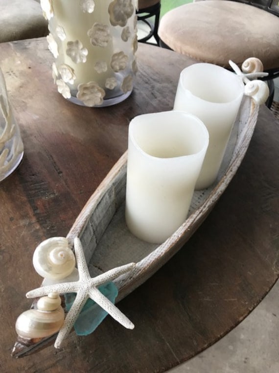 Close-up, instructional photograph, overhead shot, showing a finished driftwood and sea glass candle holder with a tea light candle in the center.