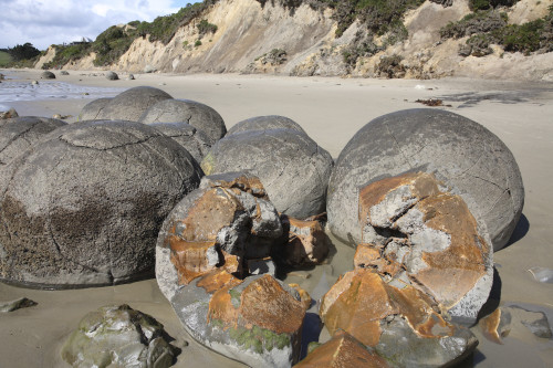 Bowling Ball Beach at sunset with smooth, round rocks reflecting the vibrant sky