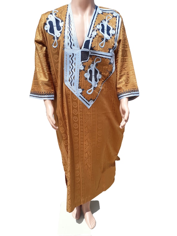 Berber man leading camels in the Sahara Desert