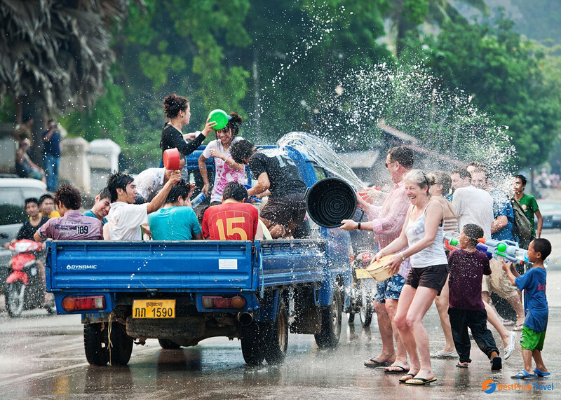 Participants dressed in traditional attire during the Nang Sangkhane procession, capturing the elaborate costumes and joyful expressions of the crowd.
