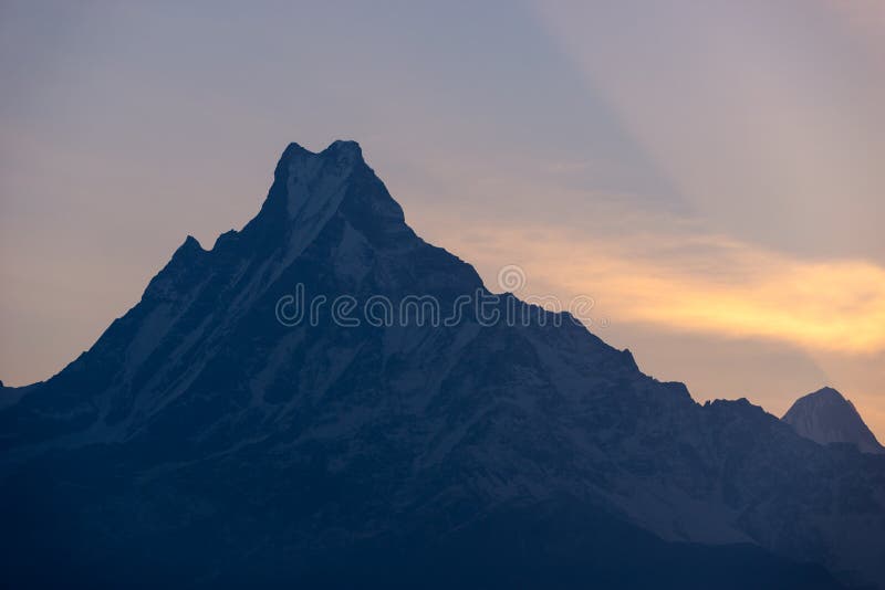 An image of the Annapurna range at sunrise with golden light illuminating the peaks, showcasing the majesty of the Himalayas and the potential for dramatic landscape photography.