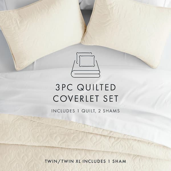 Image of a beautifully layered bed with multiple blankets, pillows, and throws.