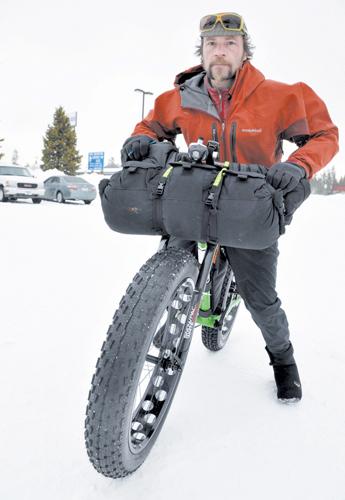 A fat biker riding through a snow-covered landscape in Yellowstone