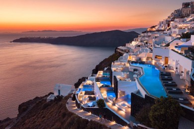 A close-up of a sunset over the caldera, showcasing the vibrant colors and dramatic landscape of Santorini. The image captures the magic and romance of the island.