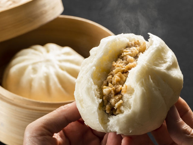 A large snow sculpture at the Sapporo Snow Festival, capturing the details and artistry involved in its creation. People are interacting with the sculpture and enjoying the festive atmosphere.