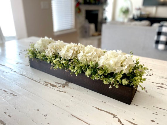 A close-up of a Modern Farmhouse dining room showing antique-style blush hydrangeas in a galvanized metal bucket.