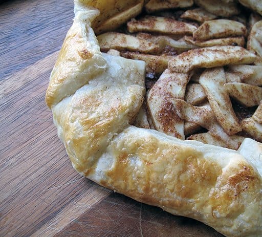 Spiced Pear and Blackberry Galette with Brown Butter Pecan Crust on a rustic wooden table