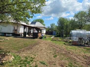 Volunteers are seen building a geodesic dome greenhouse.