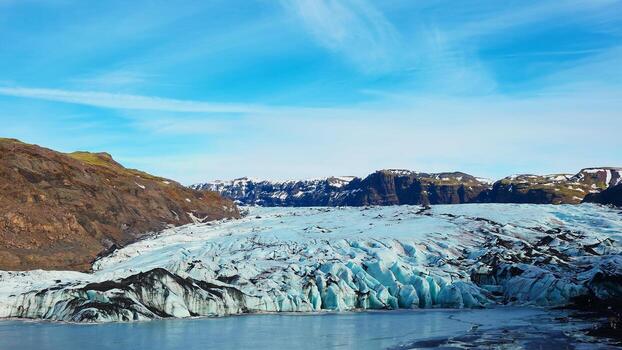 A vast, icy landscape of Vatnajökull glacier in Iceland, showcasing the scale and beauty of the glacier while also highlighting the visible effects of melting due to climate change.