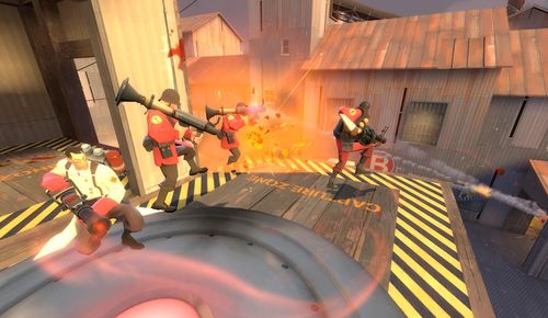 A close-up view of robotic Heavy bots firing their miniguns, highlighting the overwhelming firepower and the frustration of players.
