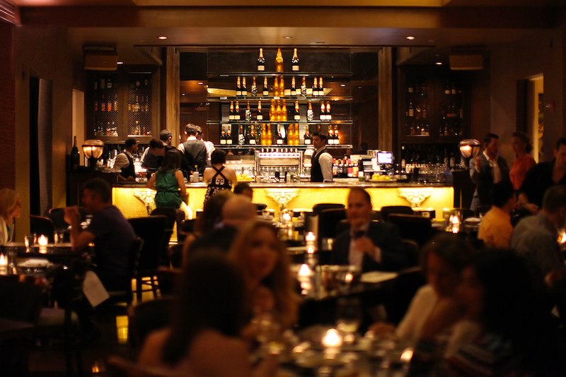 A mobile phone displaying a Facebook ad for The Cozy Bistro, targeting users in the local area