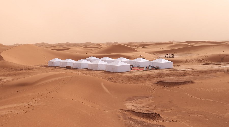 A canyoneer rappelling down a slot canyon wall