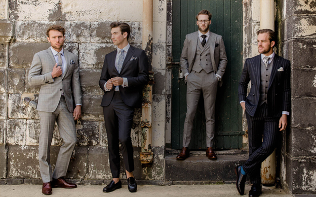 Tailor working on a garment in Hoi An, surrounded by colorful fabrics.