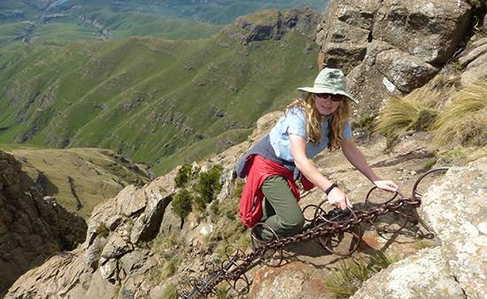A close-up of hands performing a tea ceremony in a traditional Japanese setting with mountain views.