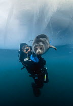 Couple ice diving in Lake Baikal