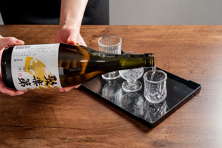 A photo of the iconic vermilion torii gates winding up the mountain.