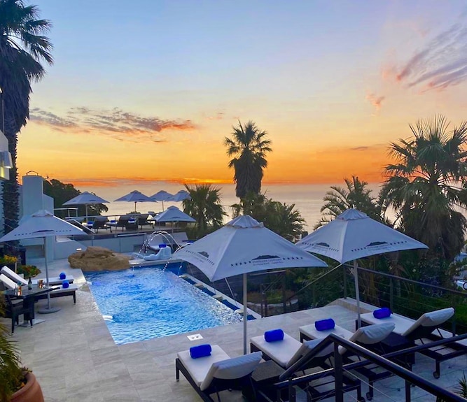 Portrait of James enjoying afternoon tea at the Granary Café, with Table Mountain visible in the background
