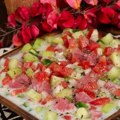 A blurry, slightly out-of-focus candid photo of Kai standing near the grave of Robert Louis Stevenson on Mount Vaea in Samoa, bathed in warm, golden afternoon light.