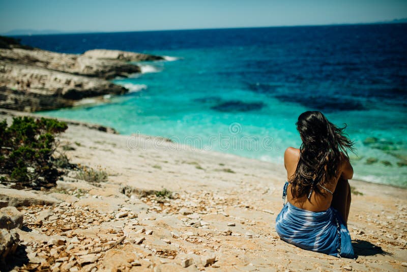 Person sculpting sand on Hot Water Beach