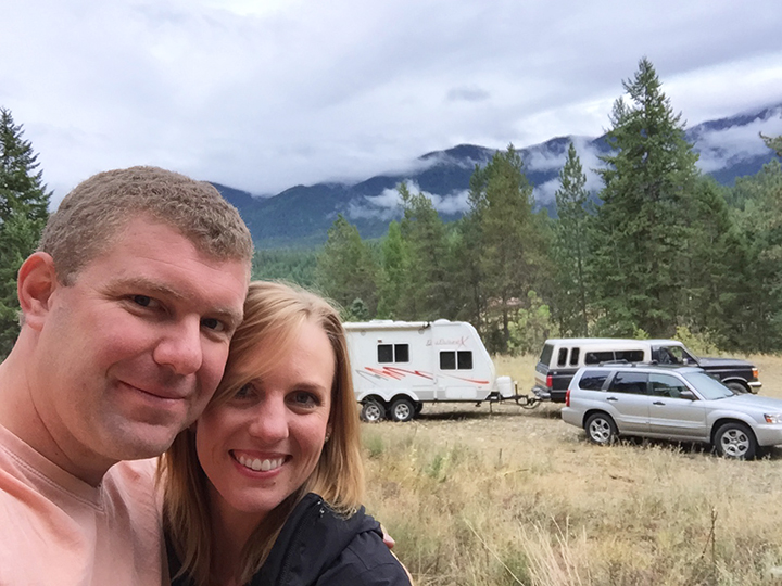 A happy family outside their homestead.