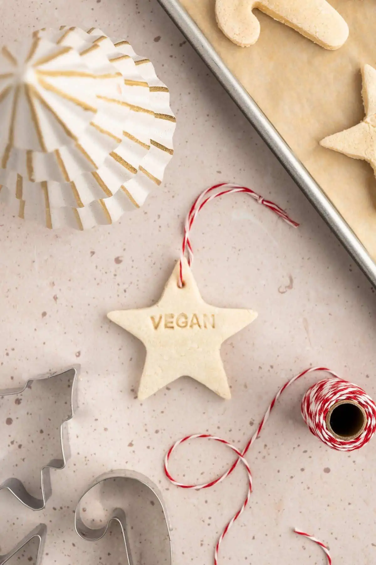 A family decorating salt dough ornaments with rosemary and other natural items