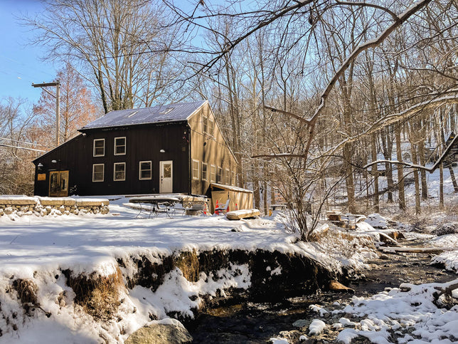 A restored barn's interior shows rustic decor and repurposed furniture.