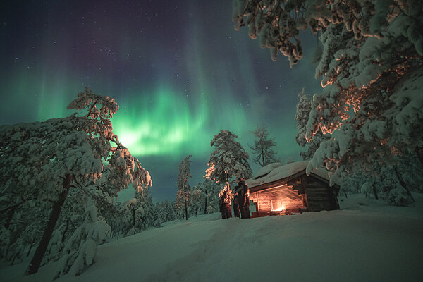 Northern Lights dancing over a snow-covered Rovaniemi landscape
