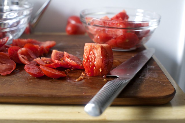 A collection of jars of canned tomatoes