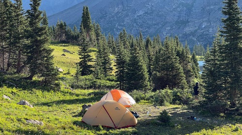 A scenic mountain landscape with a lake, emphasizing outdoor exploration.